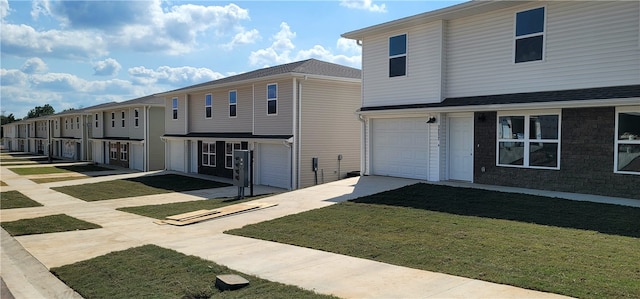 view of front of property featuring a front lawn and a garage