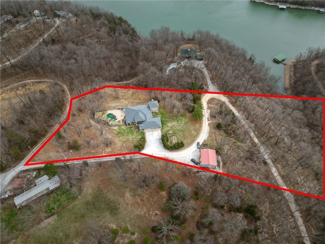 birds eye view of property with a water view