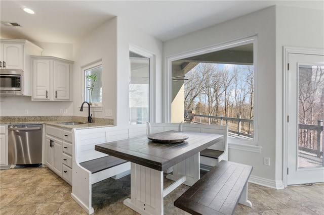 kitchen featuring white cabinets, appliances with stainless steel finishes, and sink