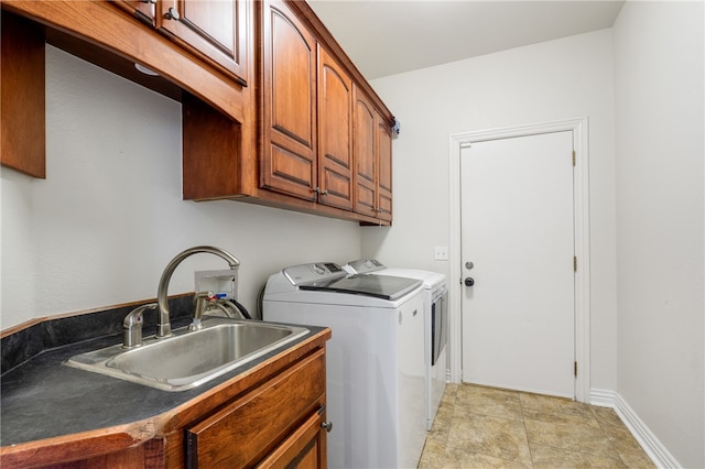 washroom with cabinets, sink, and washing machine and dryer