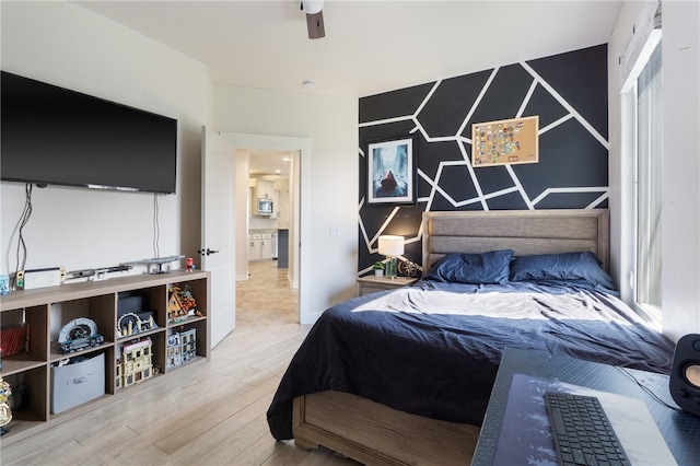 bedroom with wood-type flooring and ceiling fan