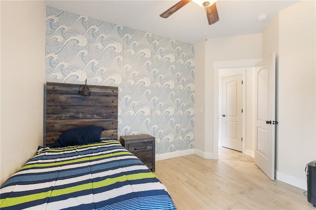 bedroom with light hardwood / wood-style flooring and ceiling fan