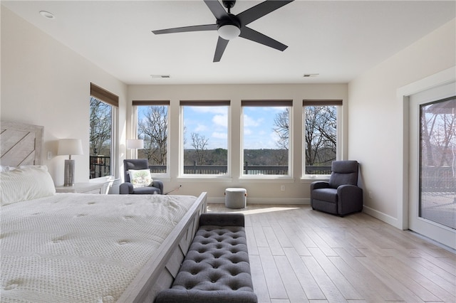 bedroom with light hardwood / wood-style flooring, ceiling fan, and access to outside