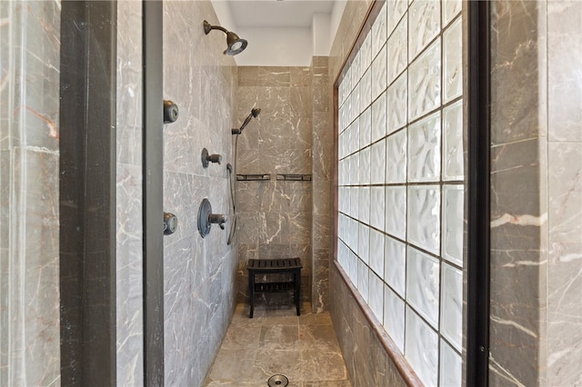 bathroom featuring tile walls and tiled shower