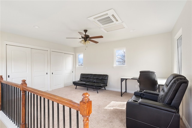 living area featuring carpet floors and ceiling fan