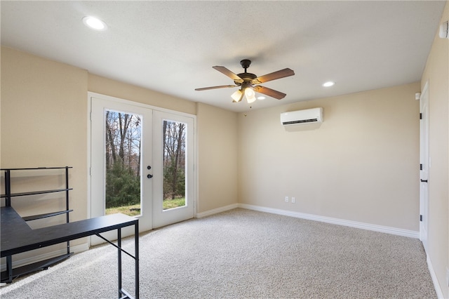 unfurnished office with light carpet, a wall mounted AC, french doors, and ceiling fan