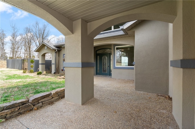 doorway to property with a yard and a patio area