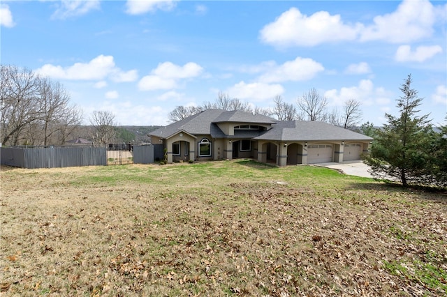 view of front of house featuring a garage and a front lawn