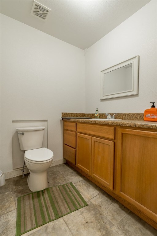 1374 Javello Rd, Tontitown, AR 72762 - bathroom with tile flooring, toilet, and vanity