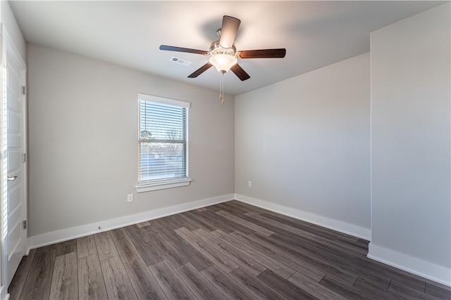 empty room with dark hardwood / wood-style floors and ceiling fan