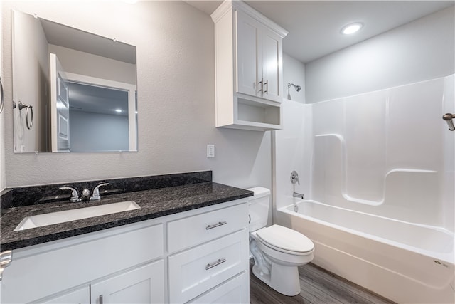 full bathroom with  shower combination, toilet, wood-type flooring, and oversized vanity