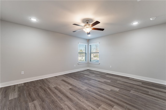 empty room featuring ceiling fan and dark wood-type flooring