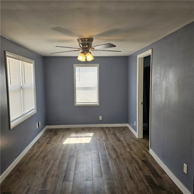 unfurnished room featuring dark hardwood / wood-style flooring and ceiling fan