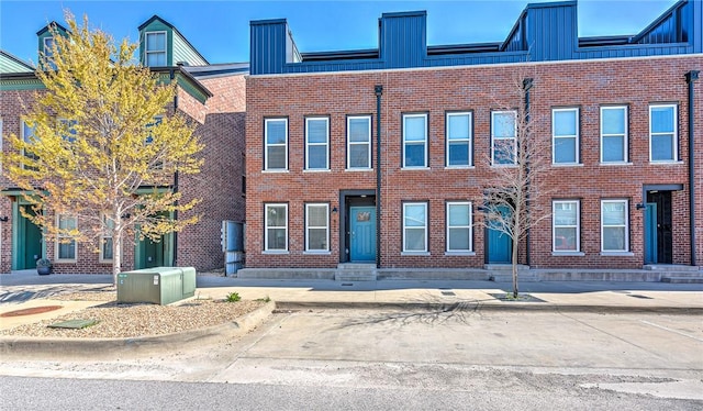 view of front of property featuring board and batten siding and brick siding