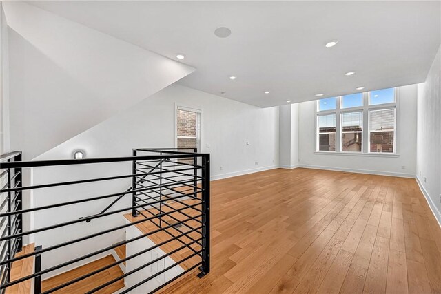 bonus room with light hardwood / wood-style flooring