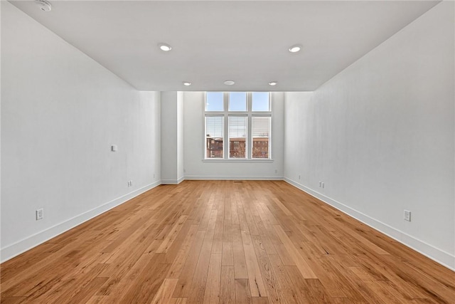 unfurnished room with recessed lighting, light wood-style floors, and baseboards