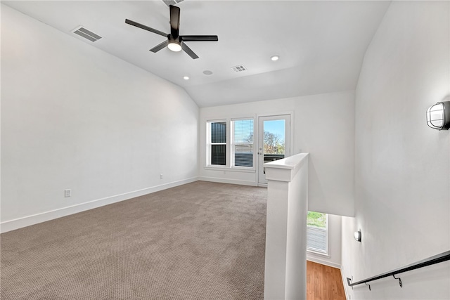 unfurnished living room featuring light carpet, ceiling fan, and lofted ceiling