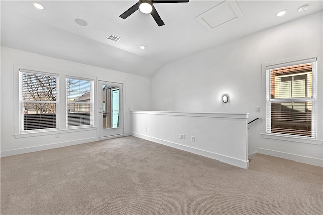 carpeted empty room featuring vaulted ceiling