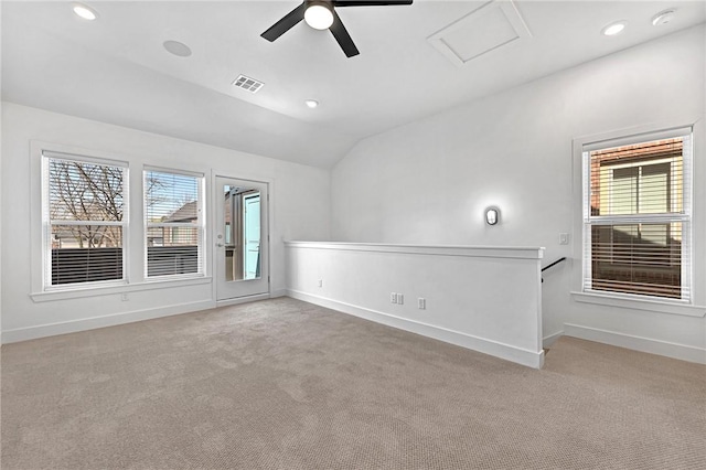 spare room featuring carpet, a healthy amount of sunlight, and visible vents