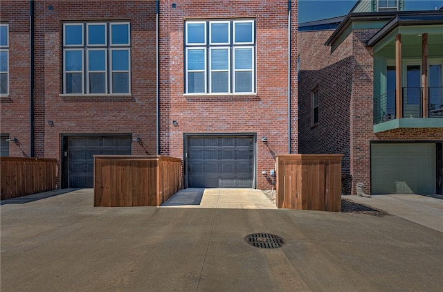 view of front of house featuring concrete driveway, brick siding, and a garage