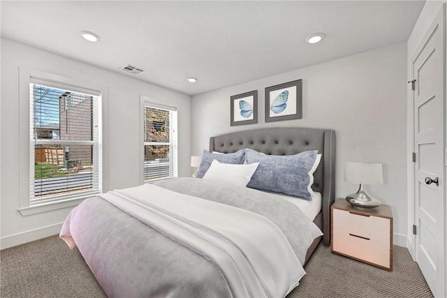 carpeted bedroom with recessed lighting, visible vents, and baseboards