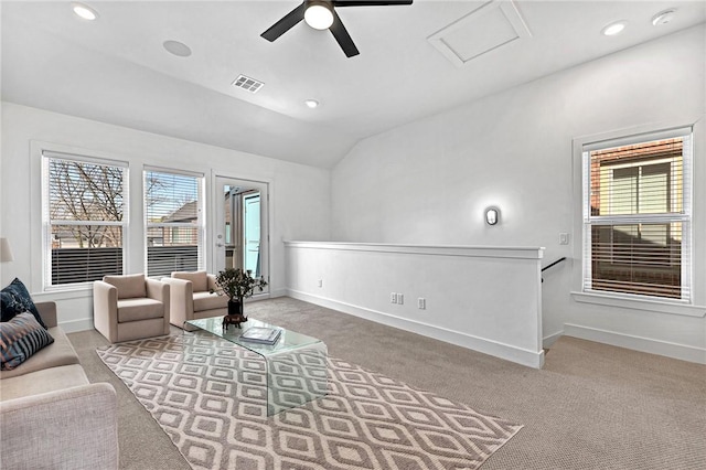 carpeted living room featuring visible vents, baseboards, attic access, vaulted ceiling, and recessed lighting