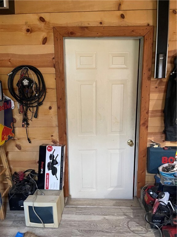 18995 Skylight Mountain Rd, Canehill, AR 72717 - doorway featuring wooden walls and light wood-type flooring