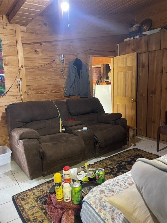 18995 Skylight Mountain Rd, Canehill, AR 72717 - living room with wooden walls, ceiling fan, wood ceiling, and light tile floors