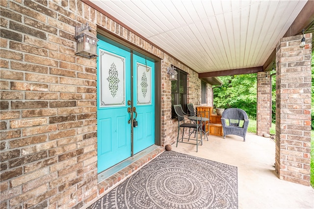 view of exterior entry featuring a porch