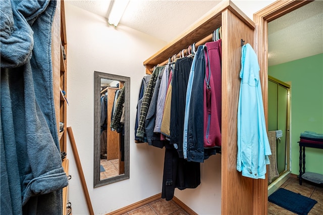 walk in closet featuring tile flooring