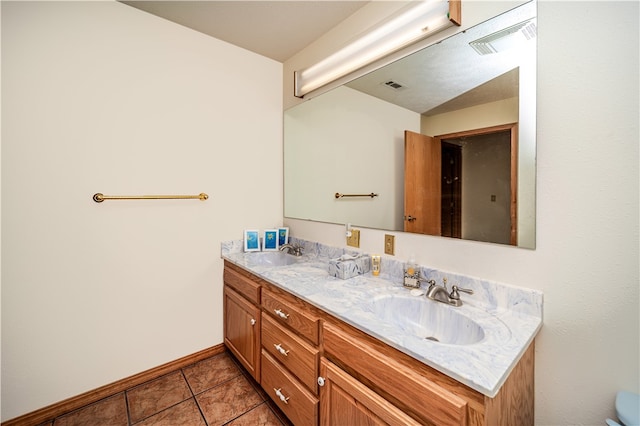 bathroom featuring tile floors, large vanity, and dual sinks