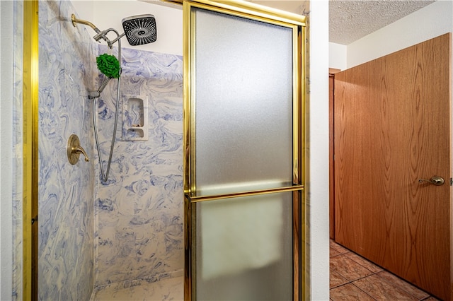 bathroom with tile floors, walk in shower, and a textured ceiling