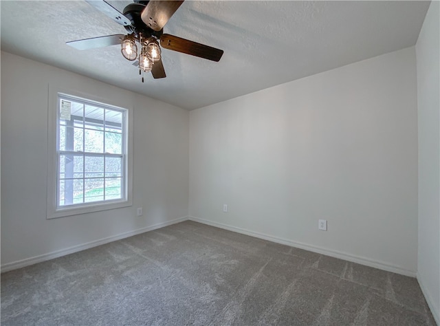 carpeted empty room featuring ceiling fan, a healthy amount of sunlight, and a textured ceiling