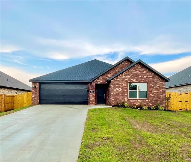 view of front of house with a front yard and a garage