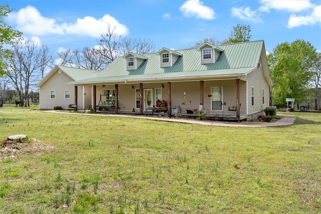 back of property featuring covered porch and a yard