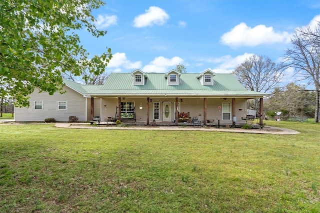 rear view of property featuring a yard and covered porch