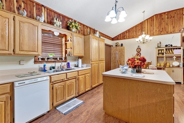 kitchen featuring hanging light fixtures, lofted ceiling, white dishwasher, a notable chandelier, and hardwood / wood-style flooring