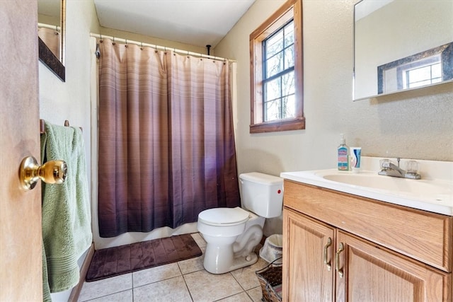 full bathroom with tile flooring, toilet, vanity, and shower / tub combo