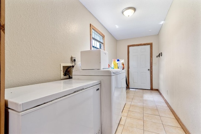 laundry area featuring hookup for a washing machine, light tile floors, and washer and clothes dryer