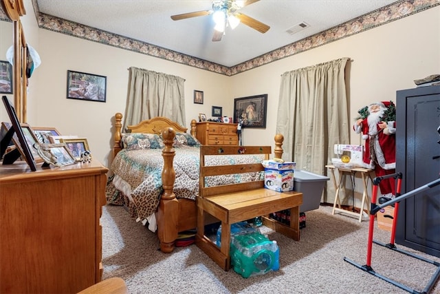 bedroom with ceiling fan, a textured ceiling, and light carpet