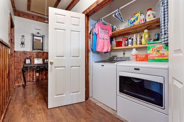 clothes washing area featuring dark hardwood / wood-style floors, washer hookup, and washer and dryer