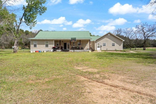 rear view of property with a lawn and a porch