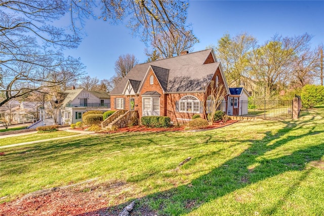 tudor home featuring a front lawn