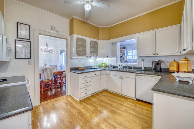 kitchen with light wood-type flooring, white appliances, ceiling fan with notable chandelier, sink, and white cabinets