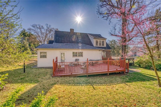 back of house with a wooden deck and a yard