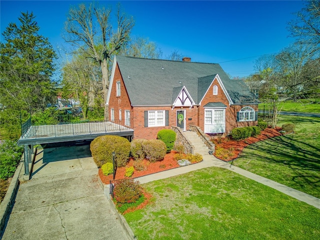 tudor-style house with a front yard