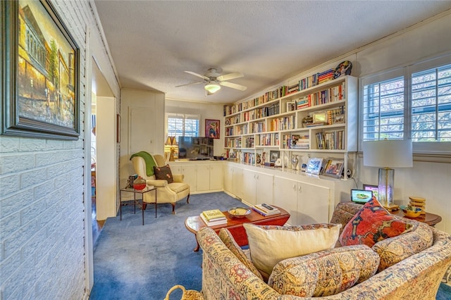 sitting room featuring ceiling fan, a textured ceiling, and dark carpet