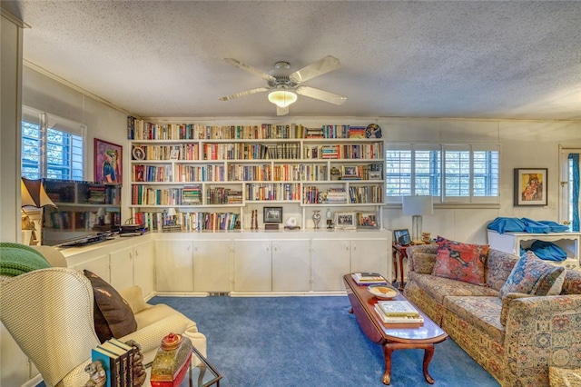 living area with carpet flooring, a wealth of natural light, and a textured ceiling