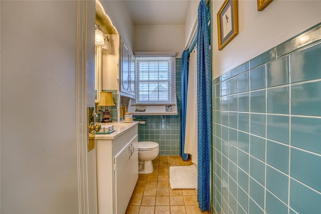 bathroom with tile walls, toilet, tile floors, and vanity