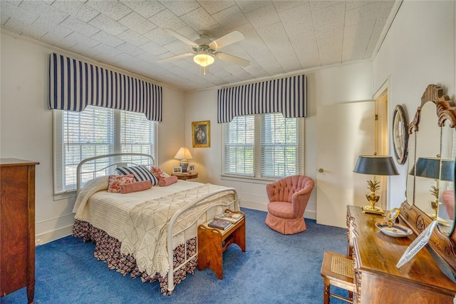 bedroom with dark colored carpet and ceiling fan